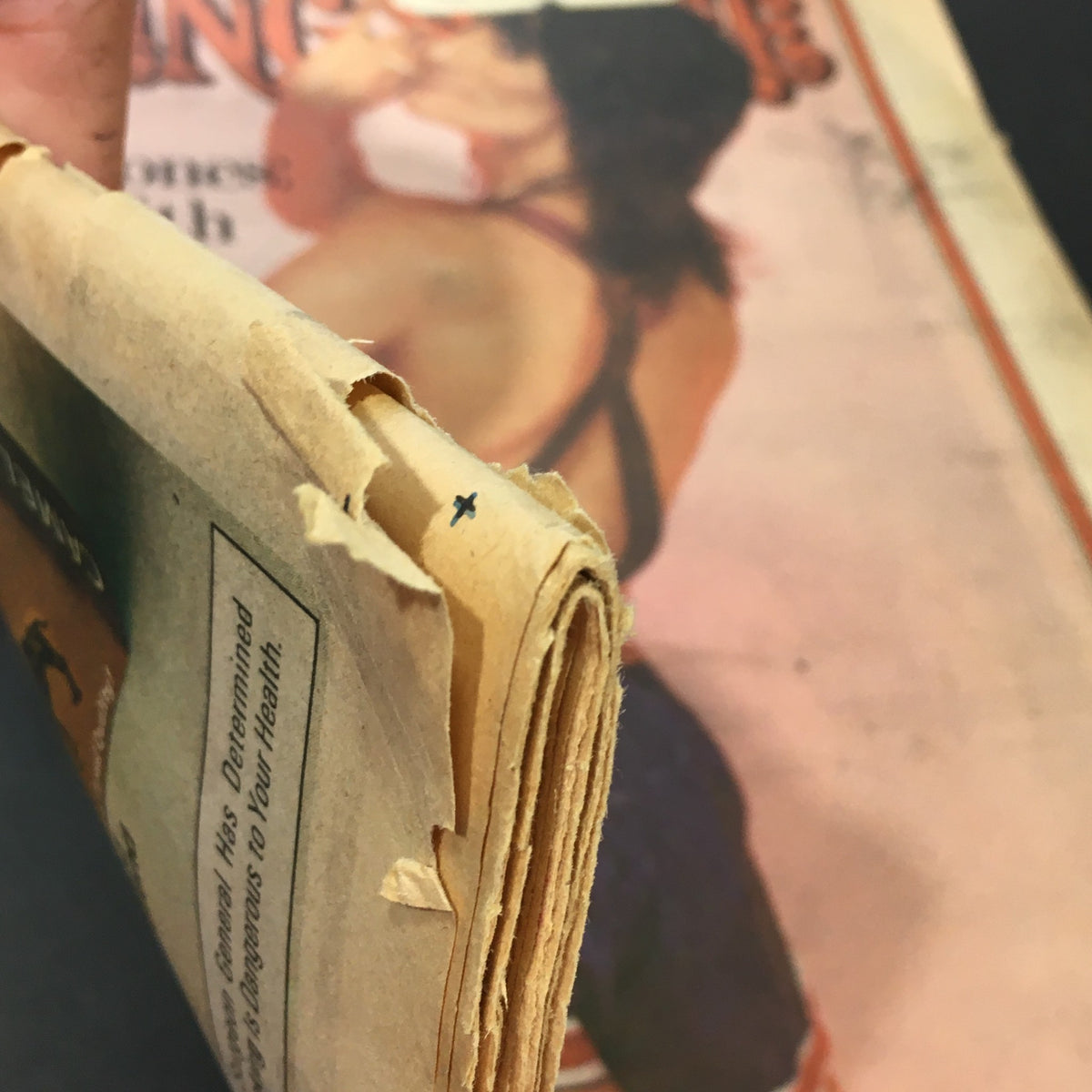 Side view of the spine of a vintage Rolling Stone Magazine from November 3, 1977, depicting the original publication with visible wear and tear on the pages, highlighting its historical significance.