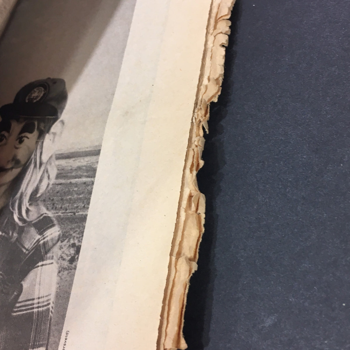 Close-up view of vintage Rolling Stone magazine January 2, 1975, highlighting the torn edges of the magazine pages, showcasing its condition and age.