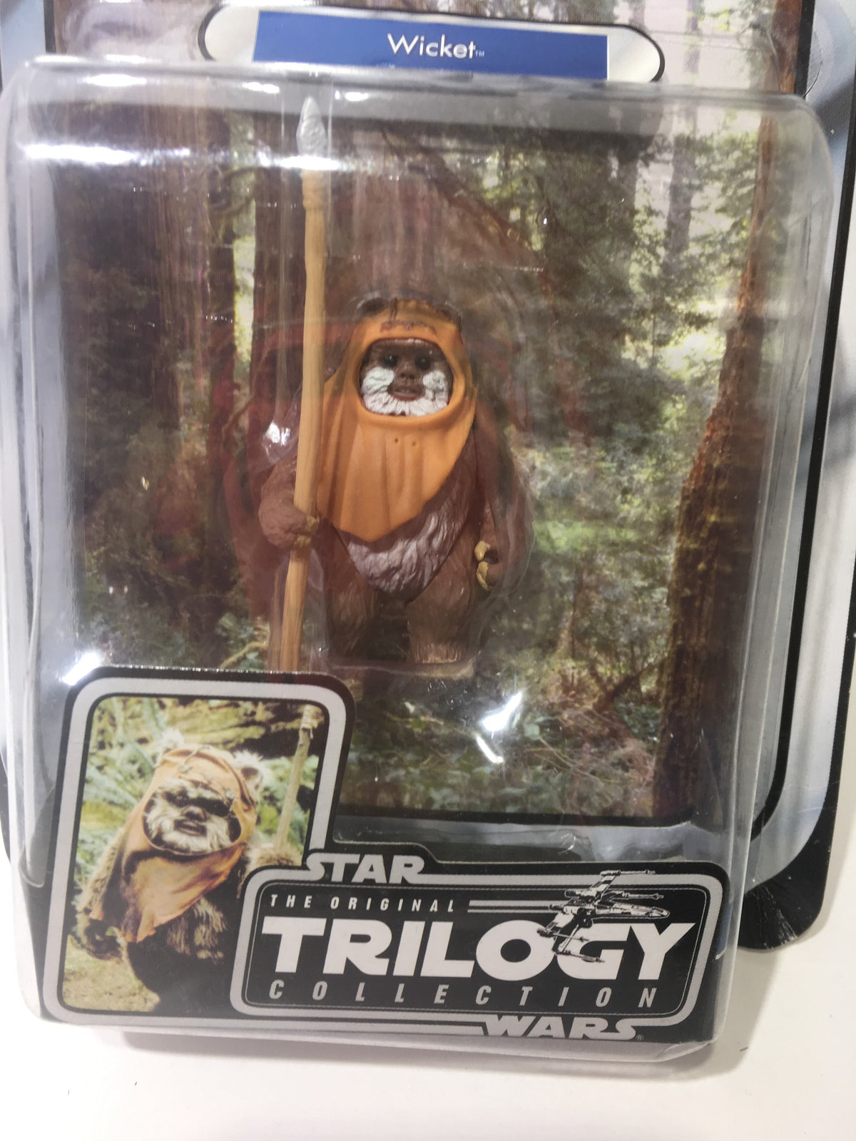 Close-up view of Star Wars Original Trilogy Collection OTC Wicket #17 action figure showing Wicket the Ewok holding a spear, with detailed packaging.
