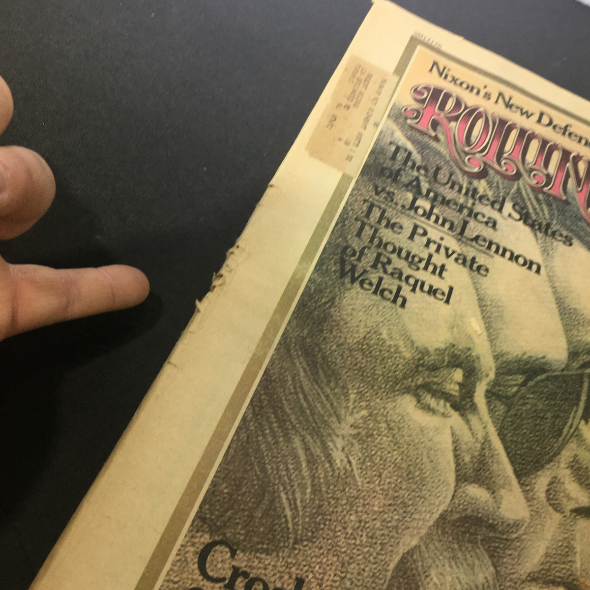 Another angle of the Vintage Rolling Stone Magazine showing signs of age, including rips and address label, with the date August 29, 1974, featuring John Lennon and Crosby, Stills, Nash.