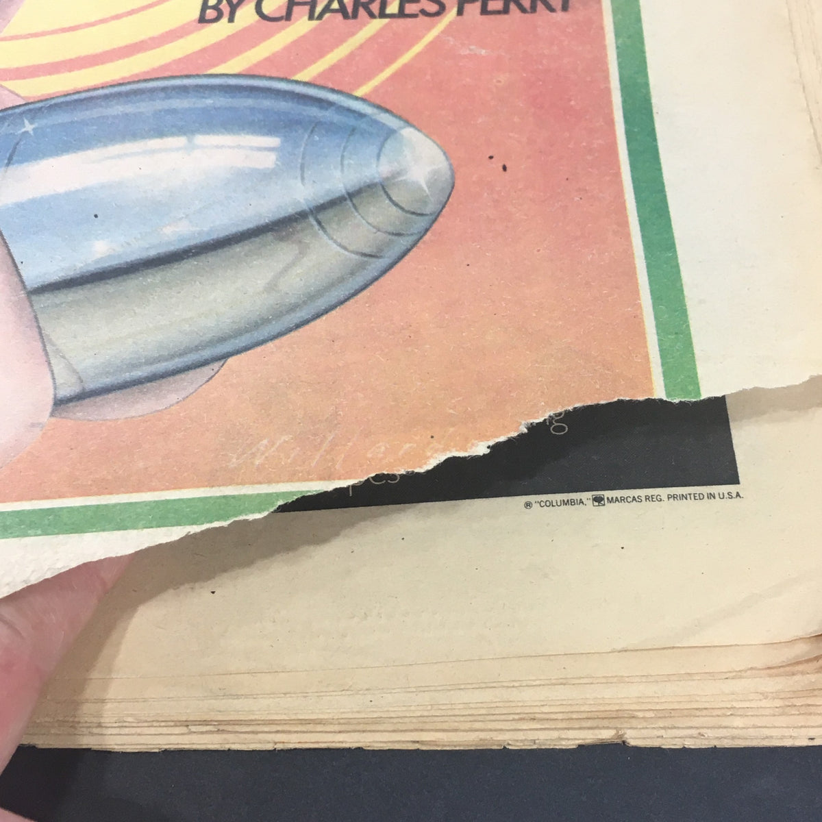 Image of the torn cover page of VTG Rolling Stone Magazine August 15 1974, focusing on the graphic design and wear, featuring the phrase 'by Charles Perry'.
