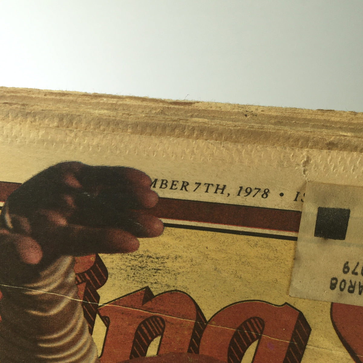 A detailed angle of the top edge of the vintage Rolling Stone magazine from September 7, 1978, displaying age-related wear and an address label, enhancing its appeal as a unique collectible.