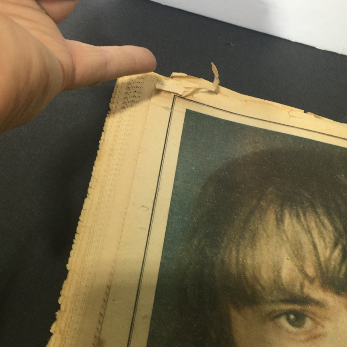 Close-up view of a damaged corner of the Vintage Rolling Stone Magazine featuring Dr. Hunter S. Thompson, showcasing wear typical of its age, including frayed edges and minor rips.