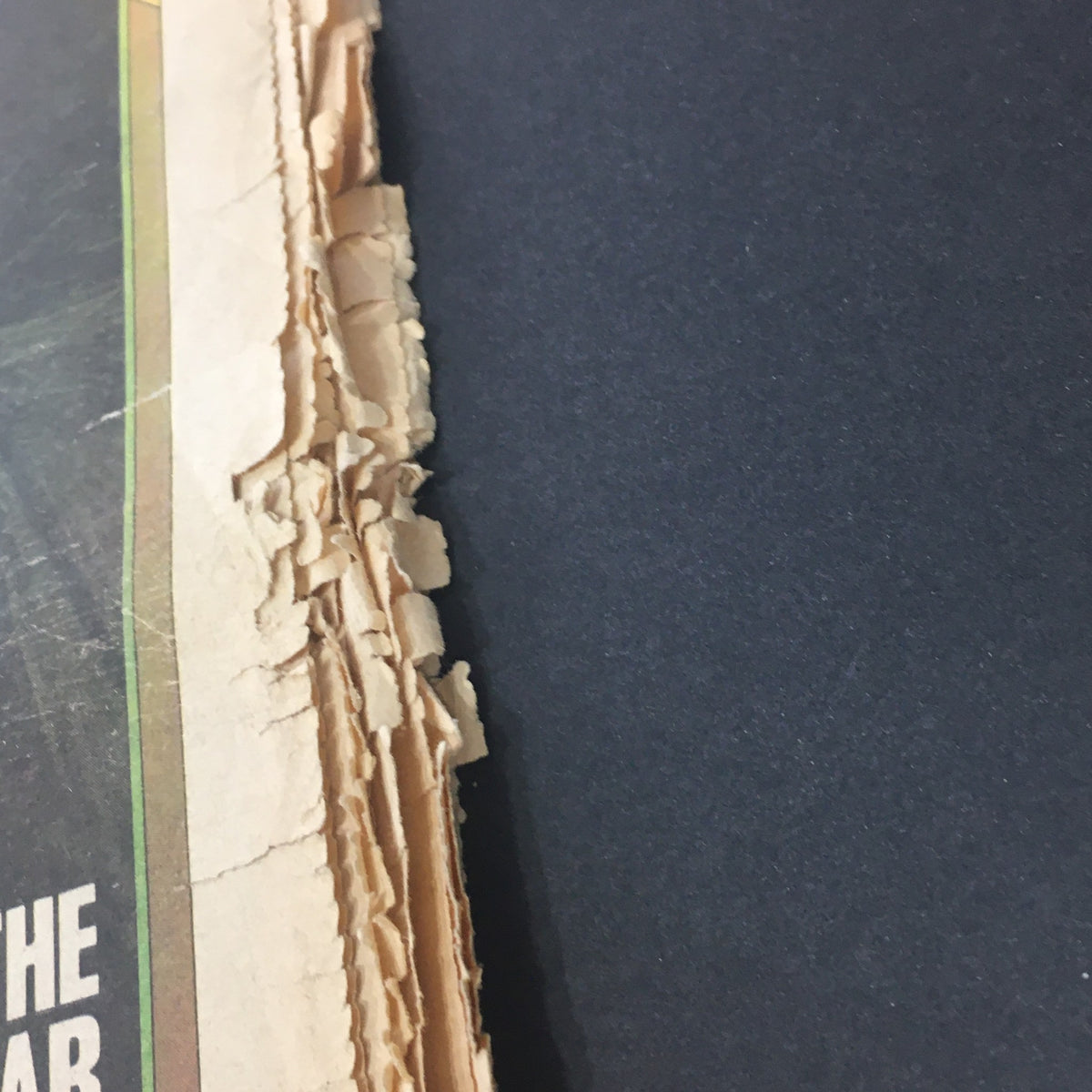 Close-up of the edge of Vintage Rolling Stone Magazine from March 27, 1975, displaying signs of wear and age.