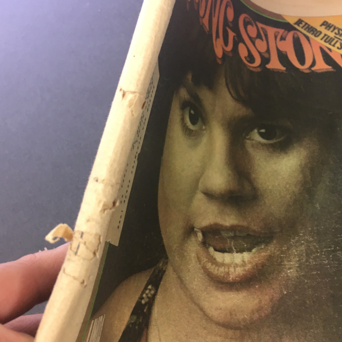 Damaged side view of the Vintage Rolling Stone Magazine from March 27, 1975, highlighting wear and tear.