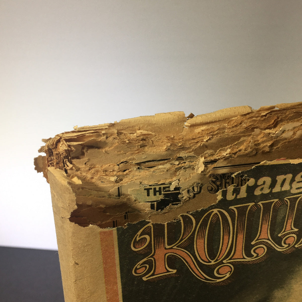 Top view of the spine of VTG Rolling Stone Magazine May 23 1974, highlighting the wear and tear indicative of a vintage publication.