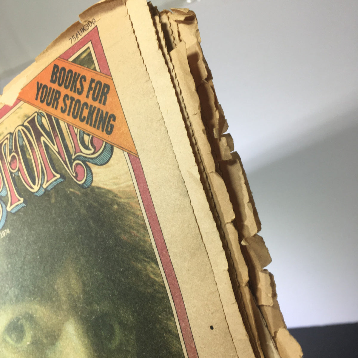 Top view of VTG Rolling Stone Magazine December 19 1974 displaying frayed edges and a promotional label.