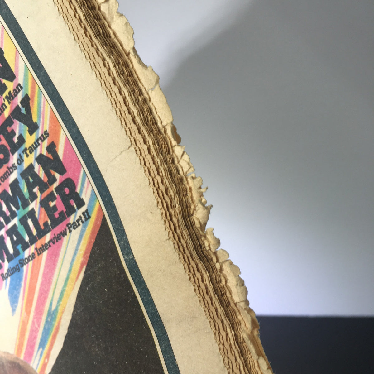 Close-up of the edge of Vintage Rolling Stone Magazine January 16, 1975, highlighting wear and rips typical for its age.