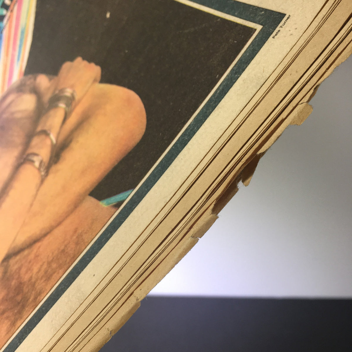 Detailed view of the pages of Vintage Rolling Stone Magazine January 16, 1975, showcasing marked edges and a glimpse of its vintage condition.
