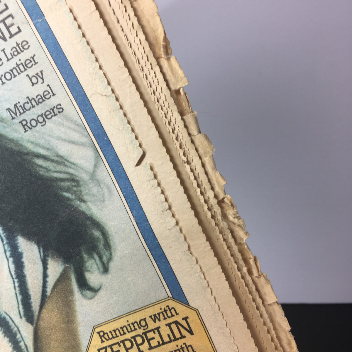 Close-up of vintage Rolling Stone Magazine from May 22, 1975 featuring Carly Simon, highlighting edge details and wear, showcasing its collectible nature.