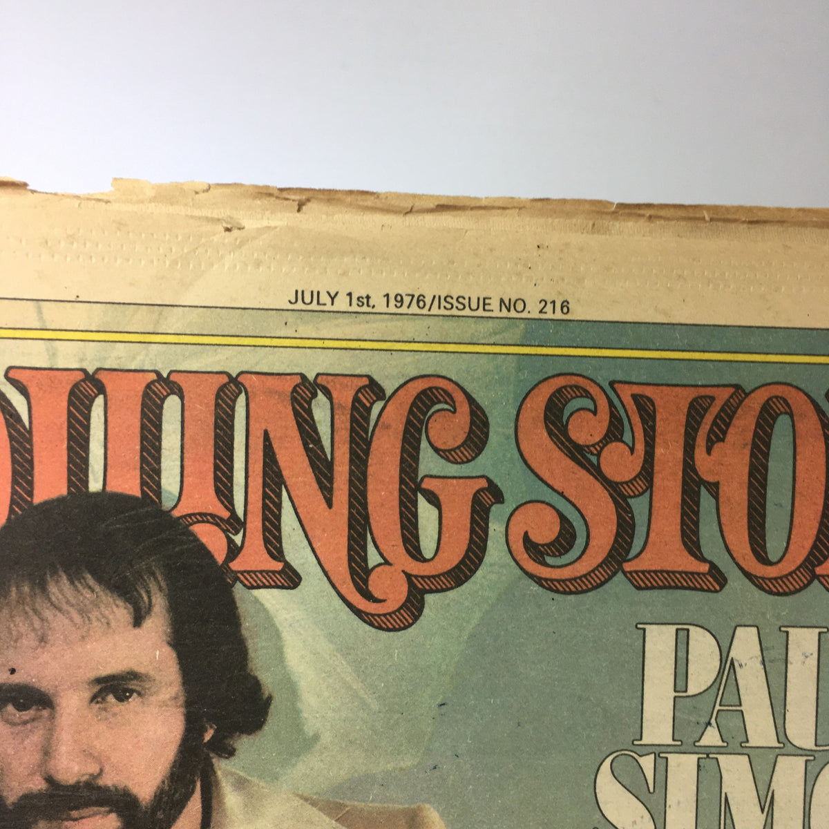 Close-up of the July 1, 1975 Rolling Stone magazine title with date and issue number, featuring Paul Simon, capturing the essence of a pivotal time in music and film history.