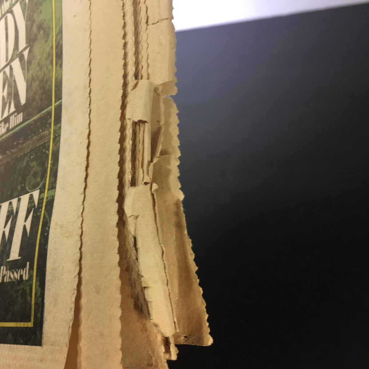 Close-up of the spine of the VTG Rolling Stone Magazine July 1, 1975 featuring Woody Allen, highlighting the aged edges typical of vintage magazines.