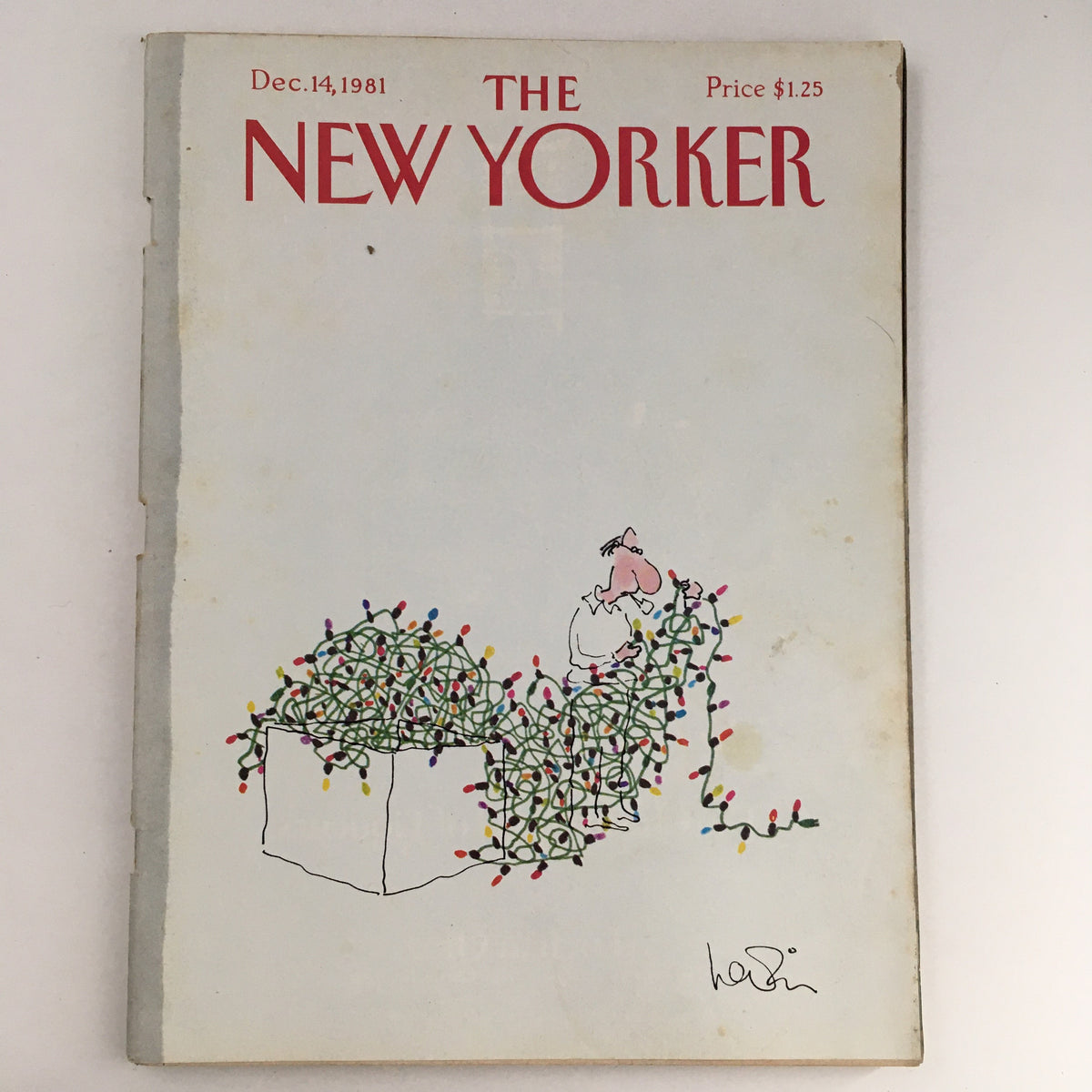 Vintage cover of The New Yorker Magazine from December 14, 1981, featuring whimsical art by Arnie Levin, illustrating a character tangled in Christmas lights.