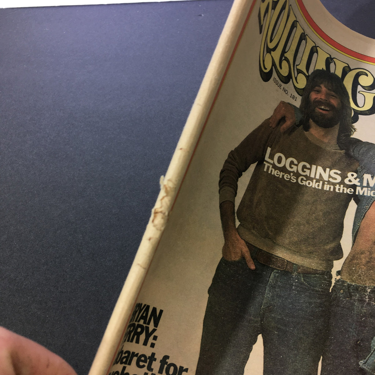 Close-up of the vintage Rolling Stone magazine cover featuring Kenny Loggins and Jim Messina from February 27, 1975. The image showcases the magazine's title and a glimpse of the artists.