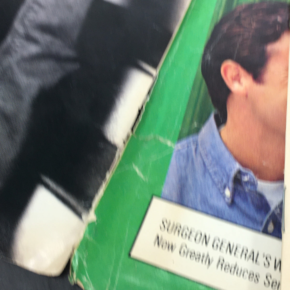 Close-up of the aged pages from the November 25, 1993, Rolling Stone Magazine, featuring a Surgeon General's warning and black and white imagery.