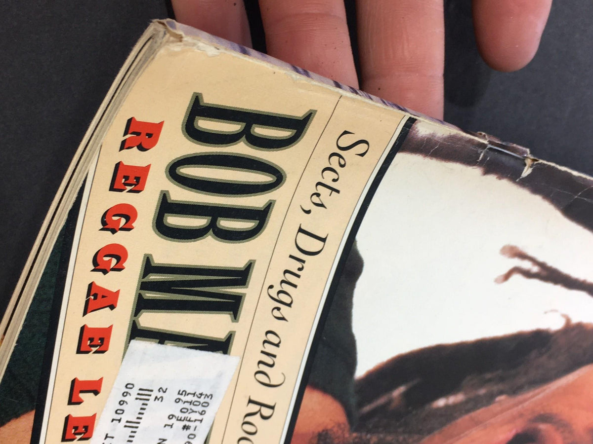 Close-up of the spine of the Vintage Rolling Stone Magazine from February 24, 1994, showcasing the title 'Bob Marley' and details of wear, emphasizing its collectible nature.