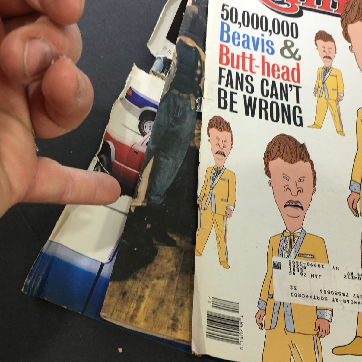 Close-up view of the spine and edge of the vintage 'Rolling Stone Magazine' featuring Beavis and Butt-Head. The magazine's wear and tear tell a story of its cultural significance in March 24, 1994.