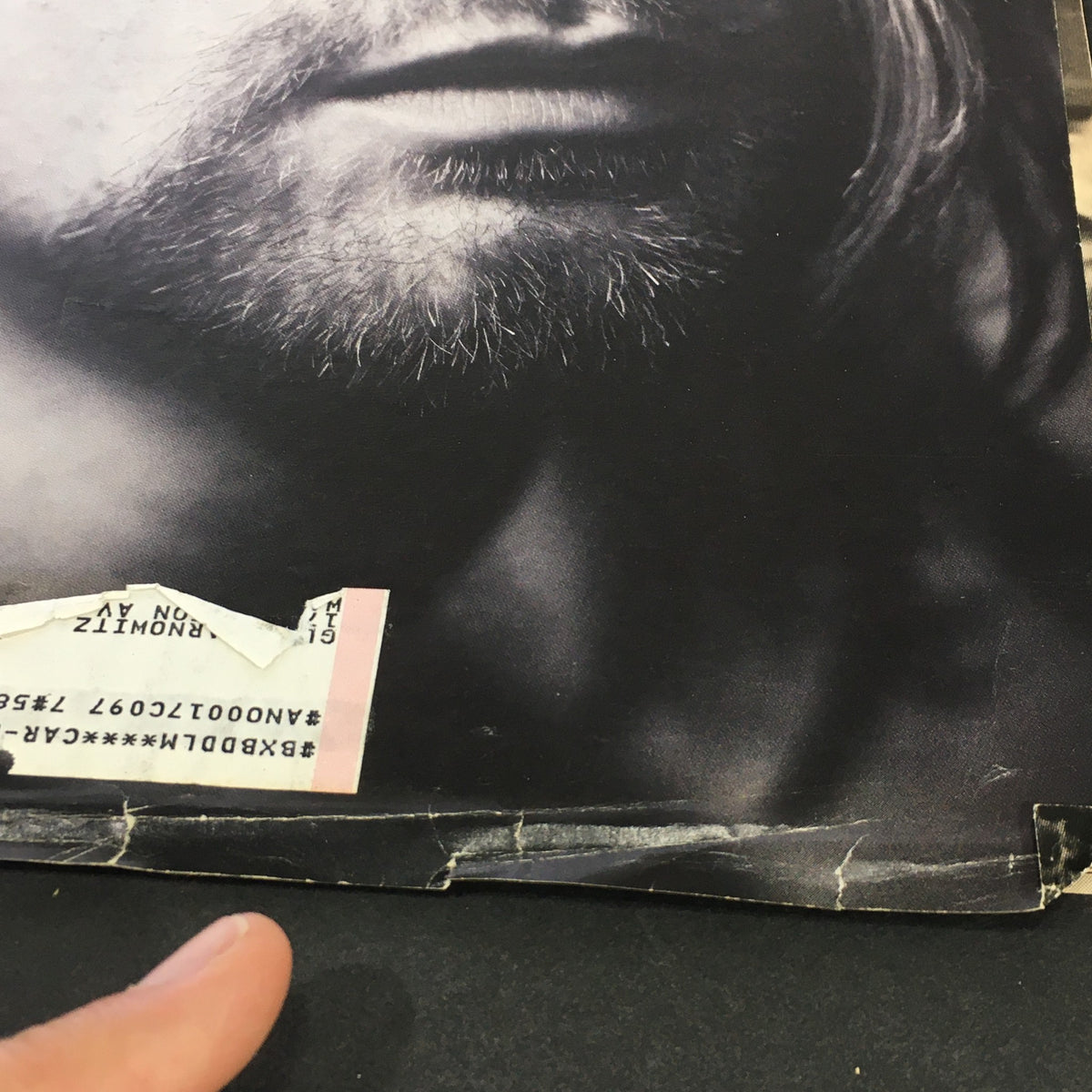 Detailed shot of the bottom edge of the Vintage Rolling Stone Magazine cover from June 2, 1994, showing the address label and wear on the cover featuring Kurt Cobain.