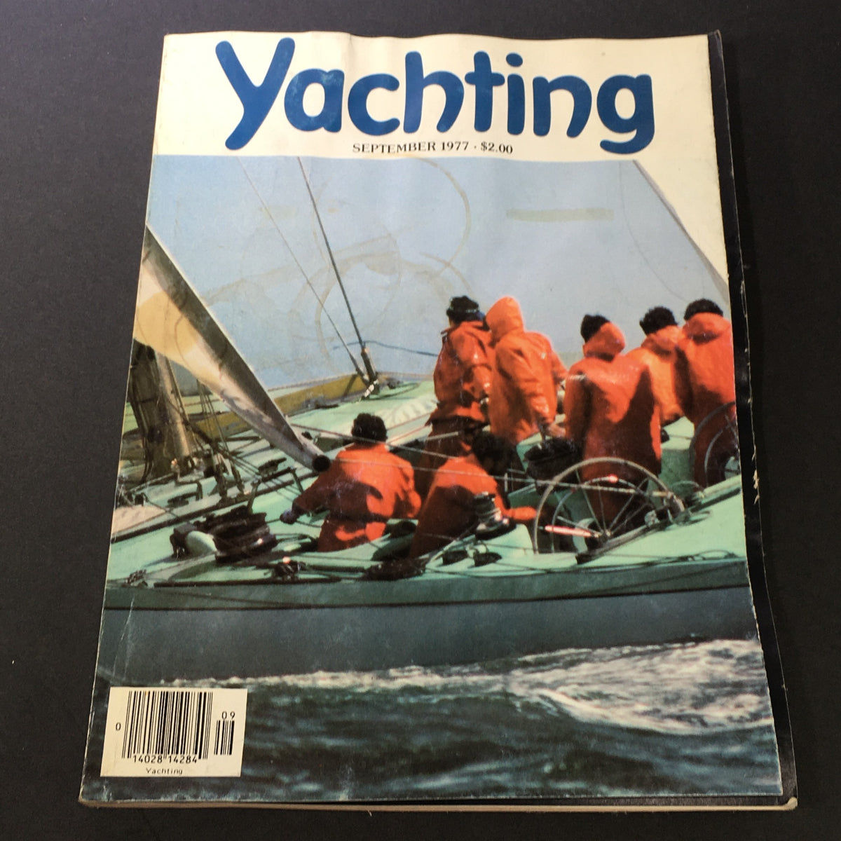 Cover of VTG Yachting Magazine September 1977 featuring competitive sailing with crew members in red jackets, highlighting the 23rd Challenge of the America's Cup Series.