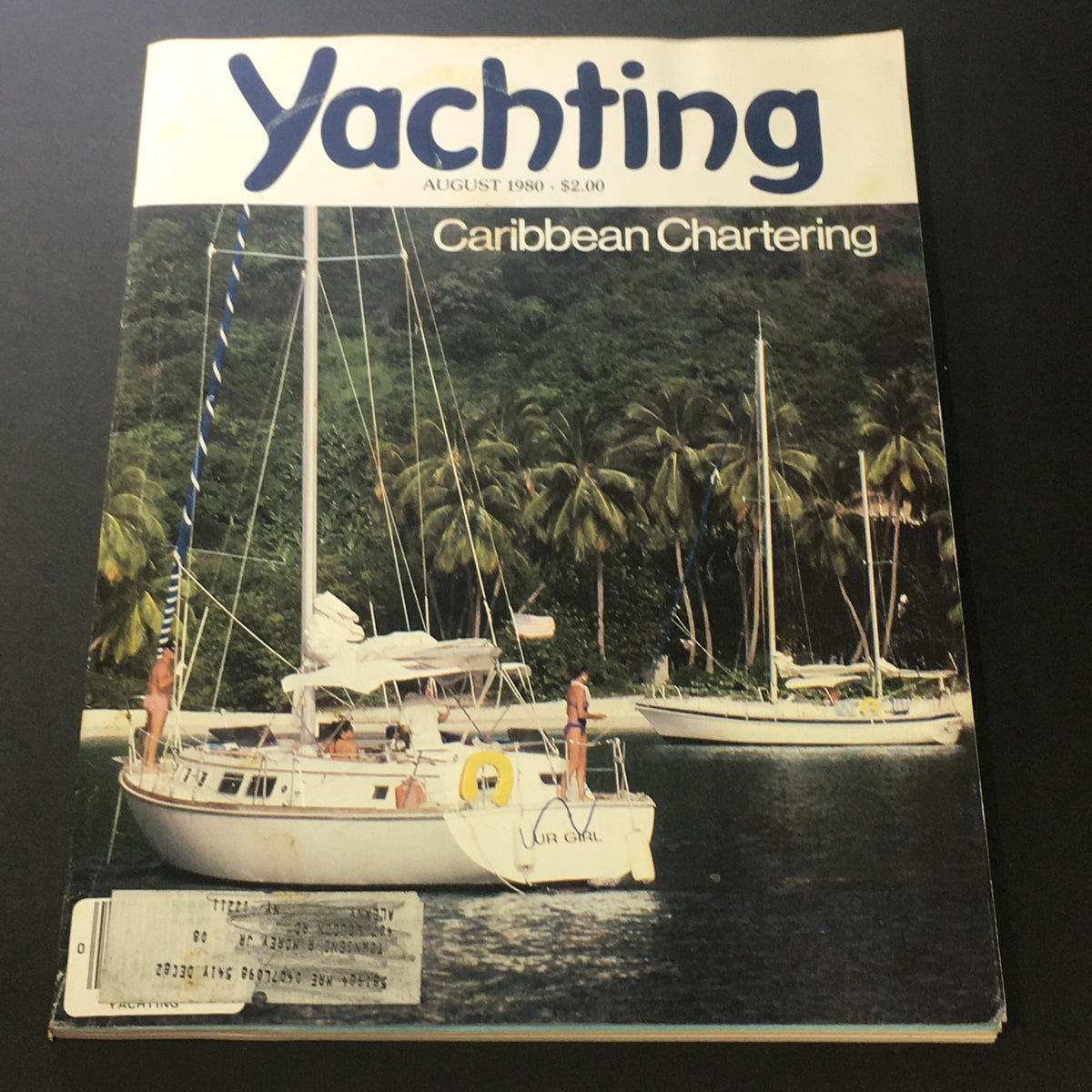 Vintage Yachting Magazine August 1980 cover featuring Caribbean Chartering with sailboats anchored near a lush tropical backdrop.