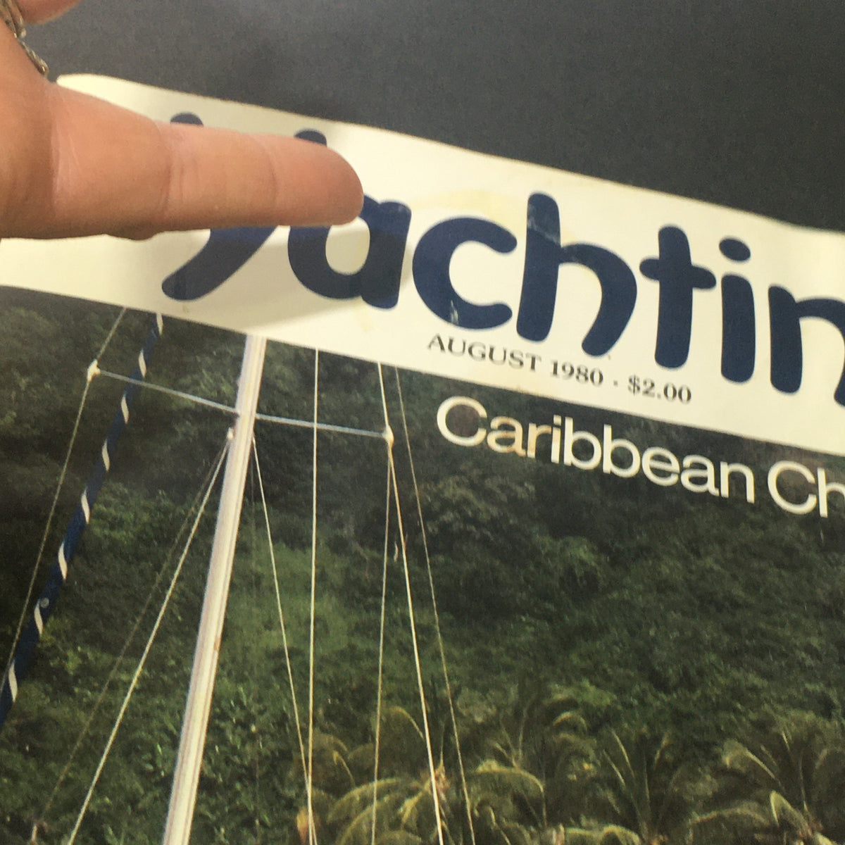 Close-up of the Vintage Yachting Magazine August 1980 title highlighting Caribbean Chartering, pointing at the magazine title.