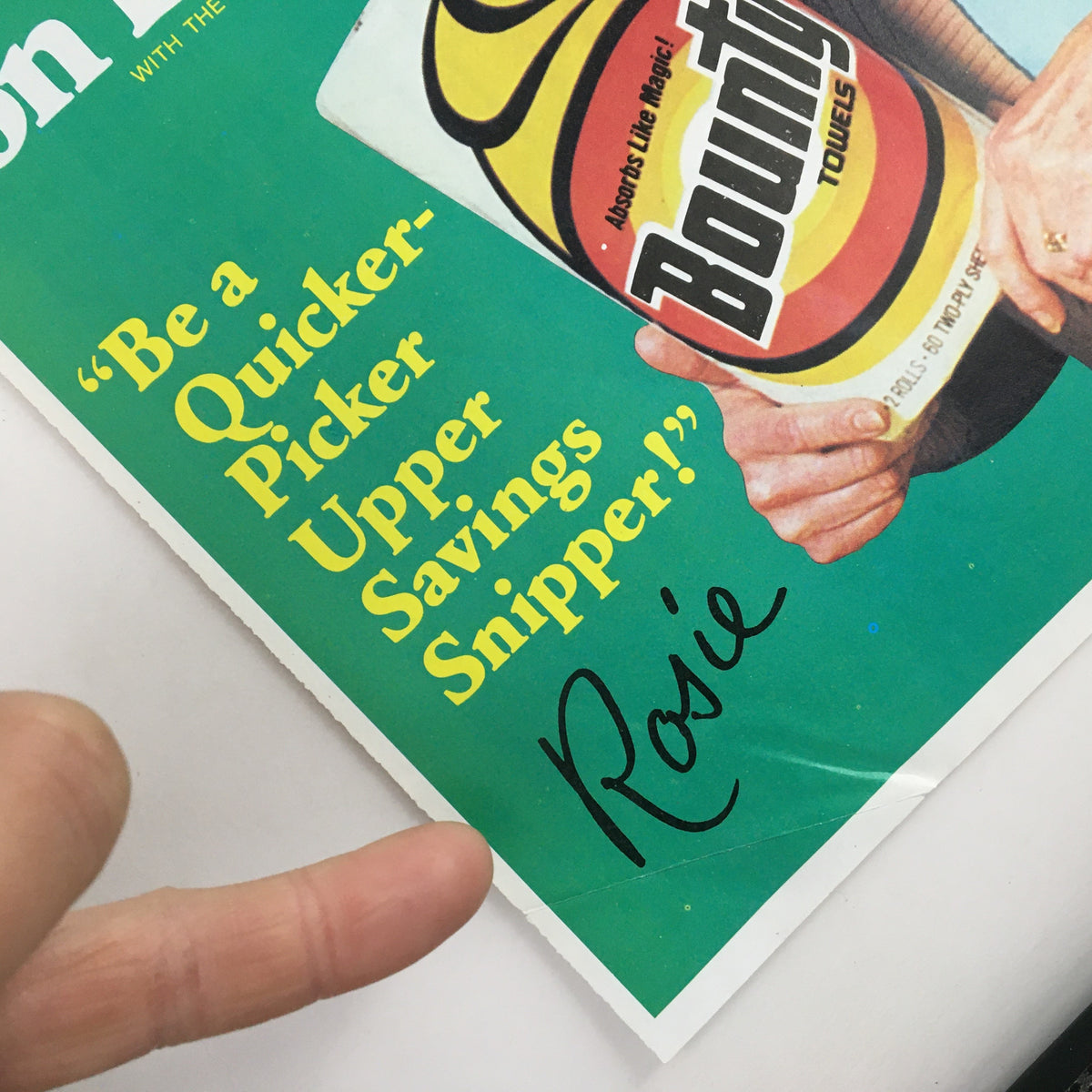 Close-up of the 1983 Bounty Coupon Advertisement, emphasizing the tagline 'Be a Quicker-Picker Upper Savings Snipper!' with the signature of Rosie.