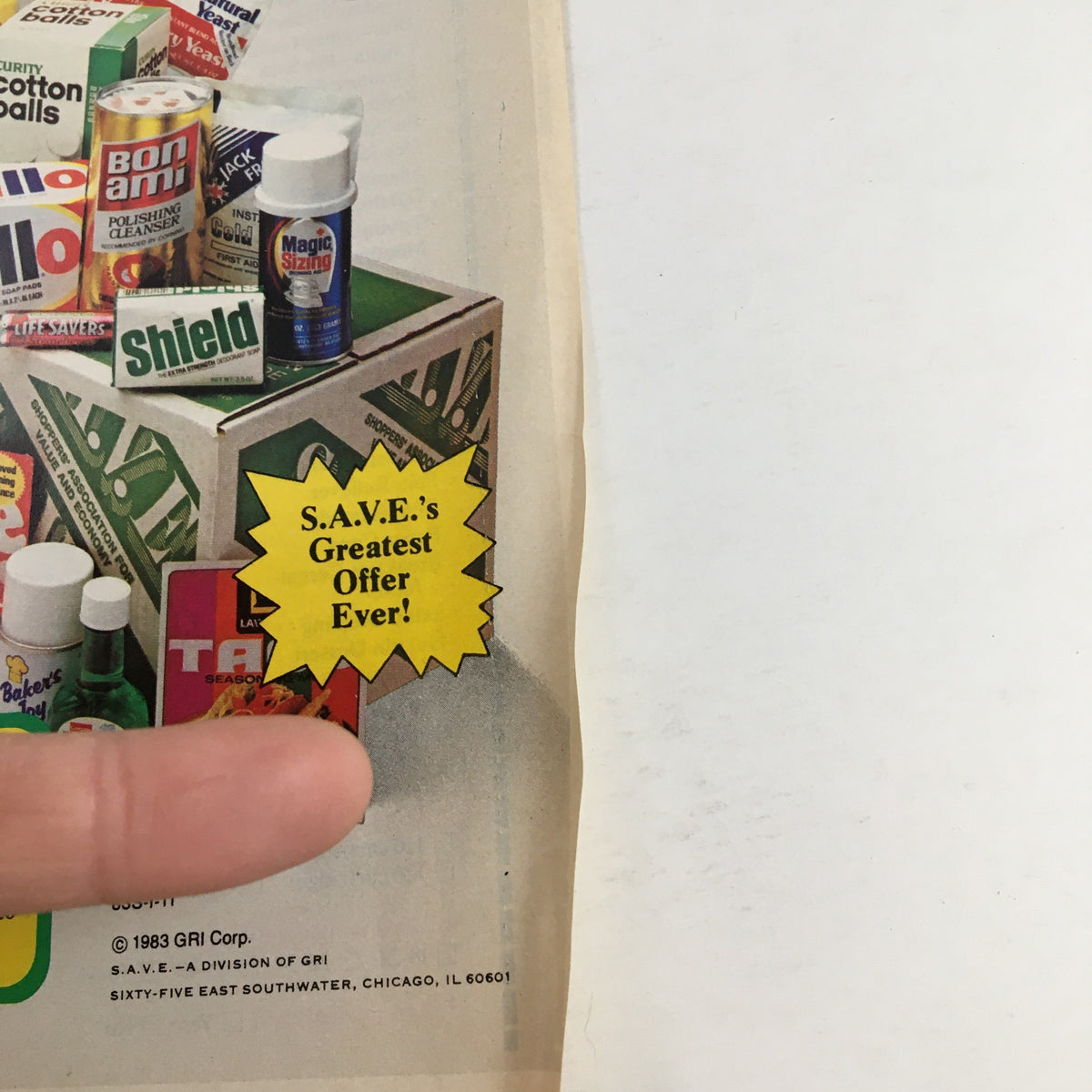 Close-up of the 1983 Save Money-Back Offer Products Circular Coupon Advertisement featuring a promotional highlight that states 'S.A.V.E.'s Greatest Offer Ever!' with a finger pointing towards it, illustrating the exciting savings offers.