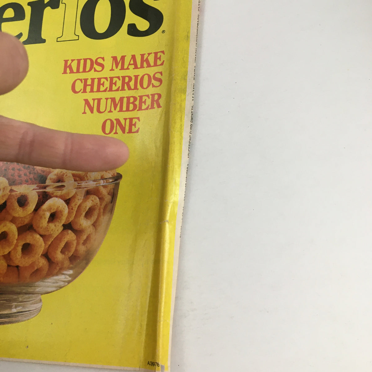 1983 Nabisco America's Leading Brands Circular Coupon Advertisement close-up of a Cheerios cereal bowl with the text 'Kids Make Cheerios Number One' visible, with a hand pointing at the image.