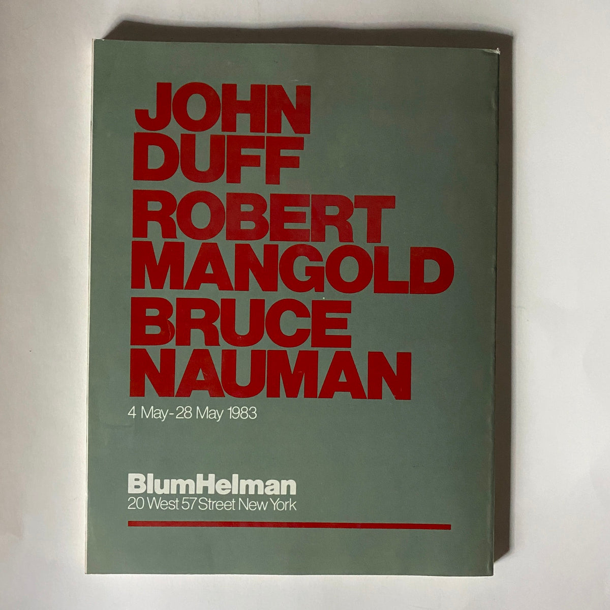 Art in America Magazine May 1983 featuring an exhibition poster for artists John Duff, Robert Mangold, and Bruce Nauman, promoting their work from May 4 to May 28, 1983, at BlumHelman gallery, New York.