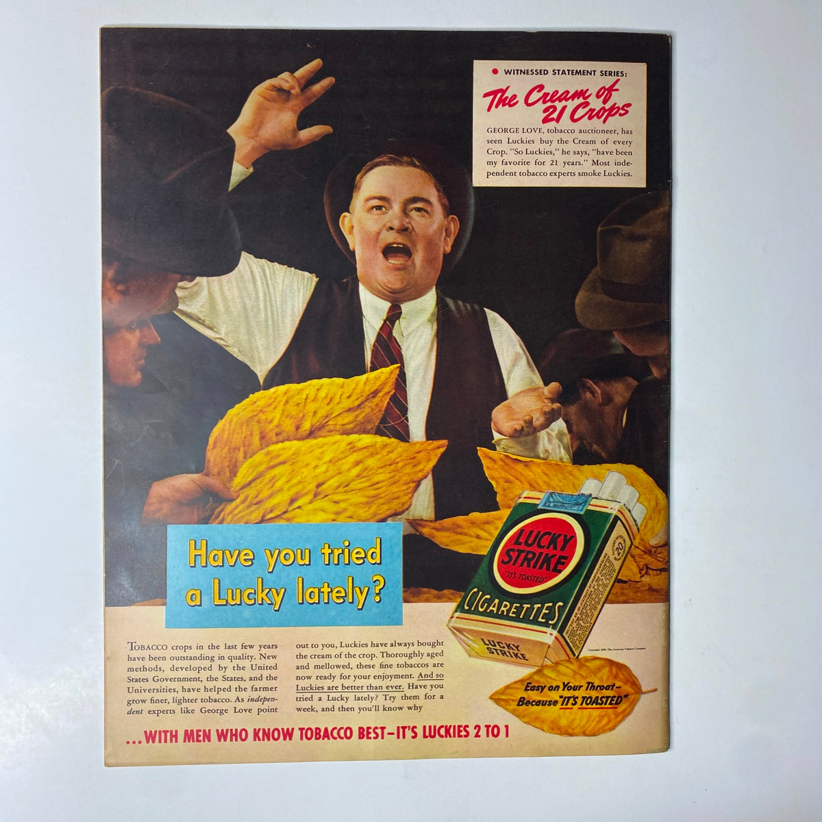 Image from Look Magazine March 28, 1939 displaying a colorful advertisement for Lucky Strike cigarettes featuring tobacco auctioneer George Love. The ad emphasizes the quality of Lucky Strike tobacco and invites readers to try it.