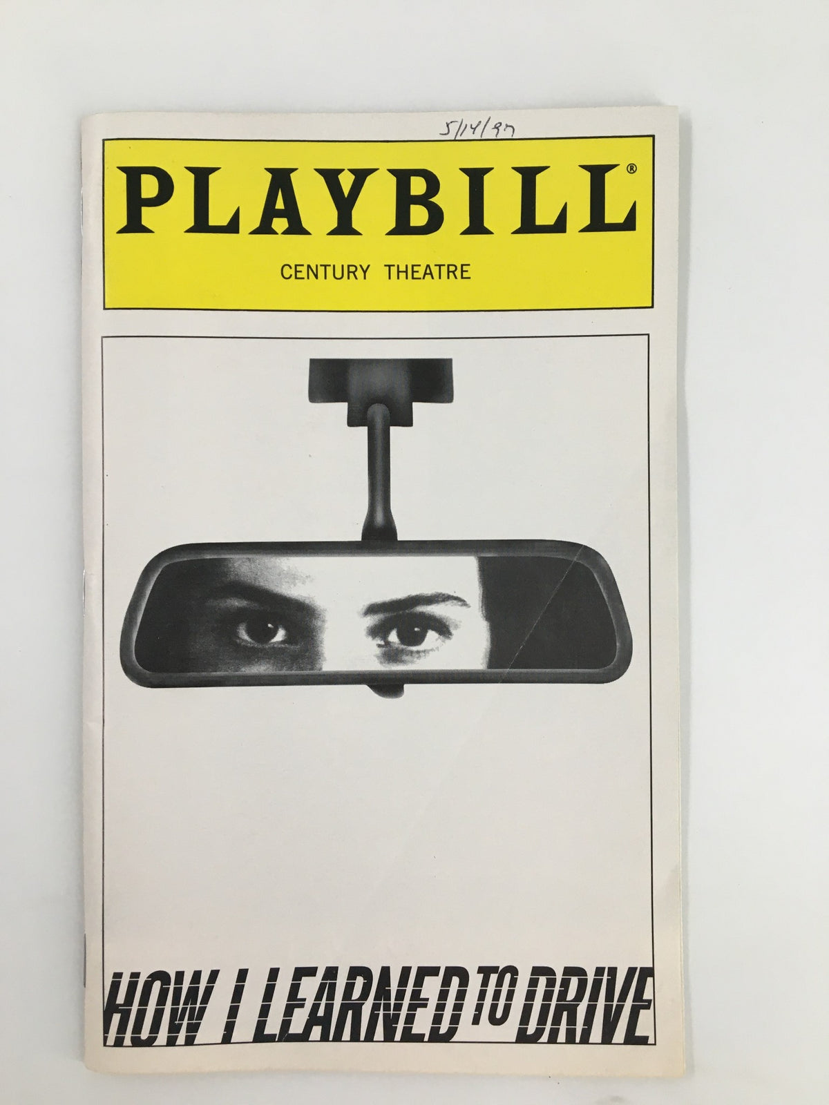 1997 Playbill for 'How I Learned To Drive' featuring a reflective rearview mirror and the title with a close-up of eyes, from the Century Theatre.