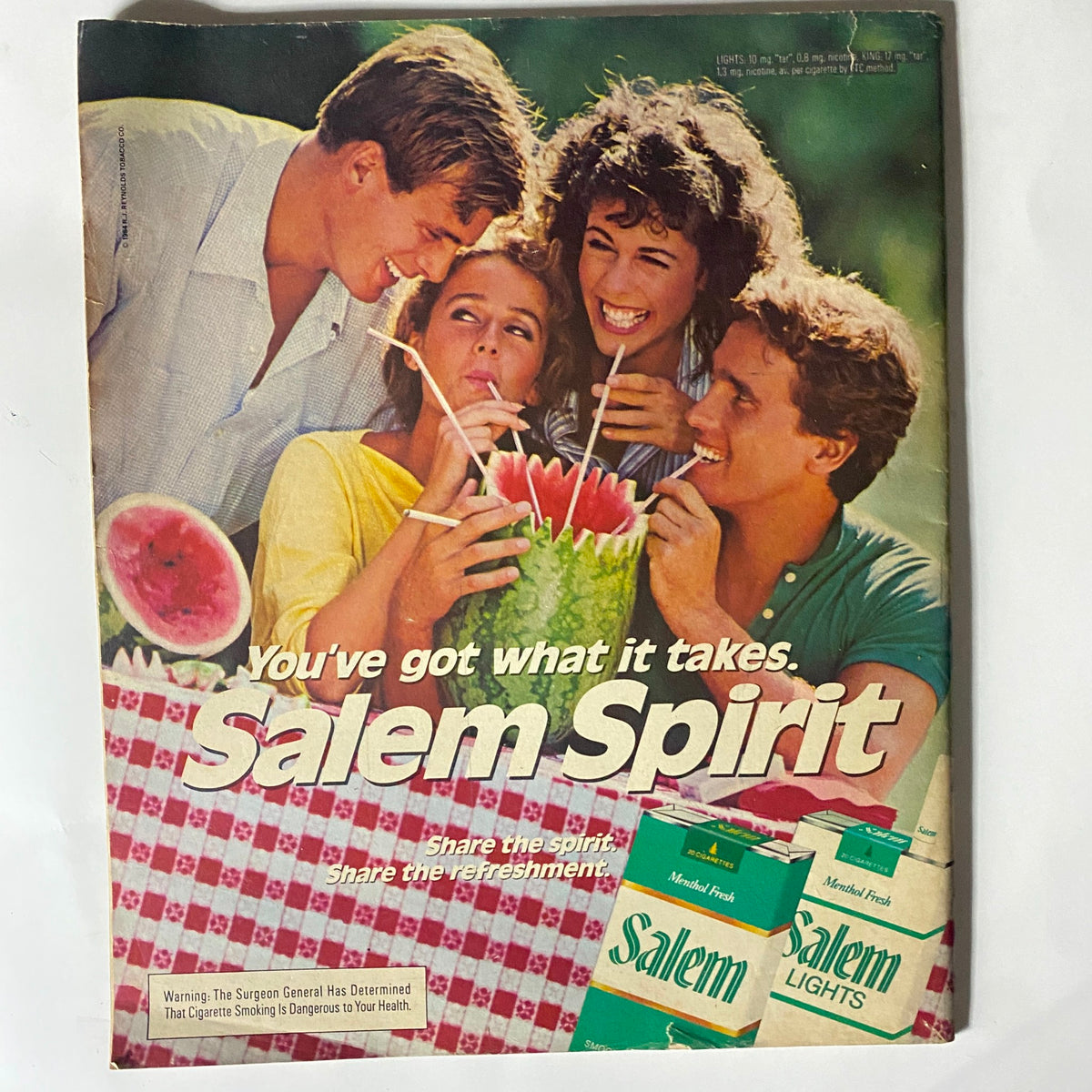 Cover of Salem Spirit advertisement with four young adults enjoying a watermelon drink, highlighting a vintage lifestyle theme, emphasizing the tagline 'You've got what it takes'.