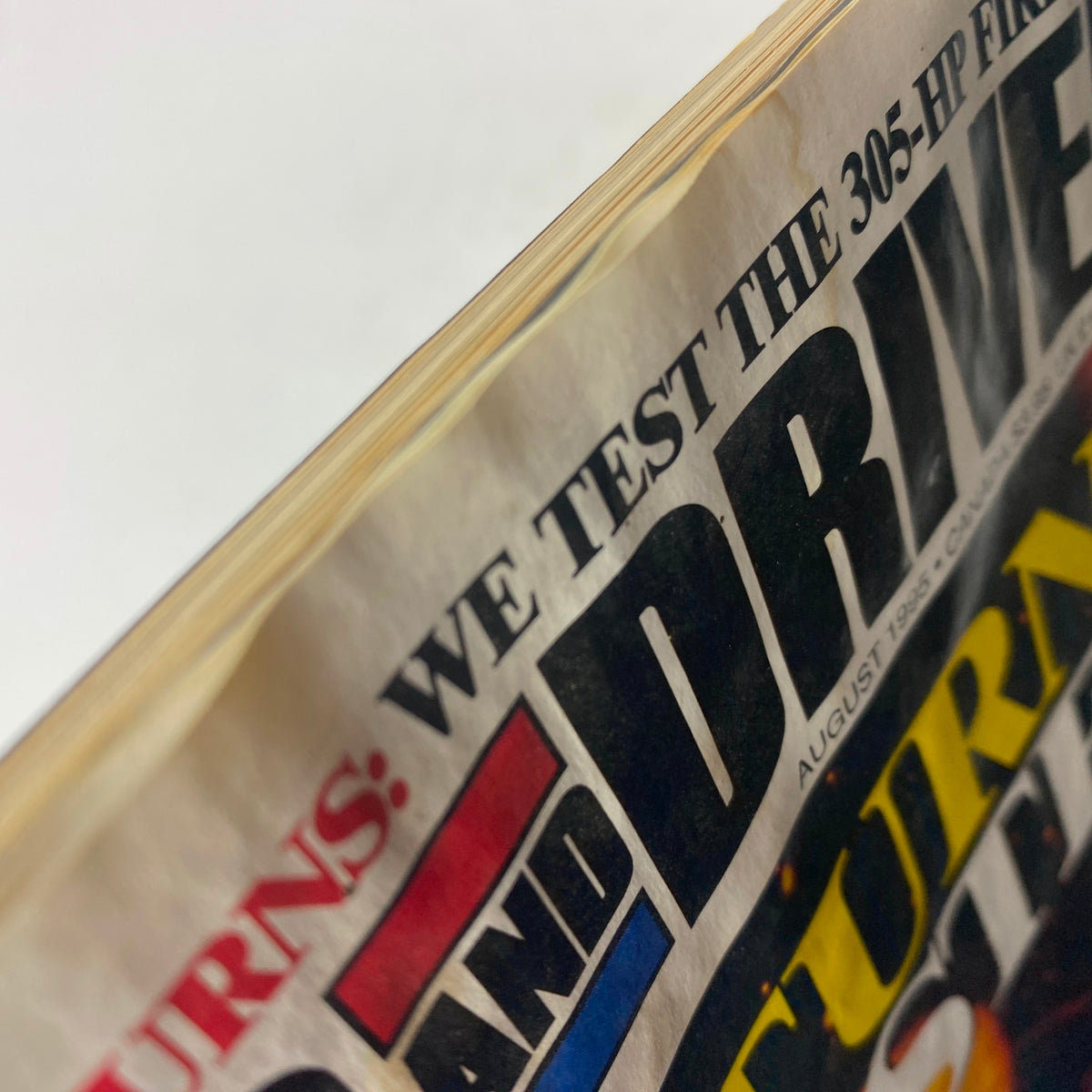 Close-up view of the Car and Driver Magazine, August 1995, focusing on the bold title and headlines related to automotive reviews.