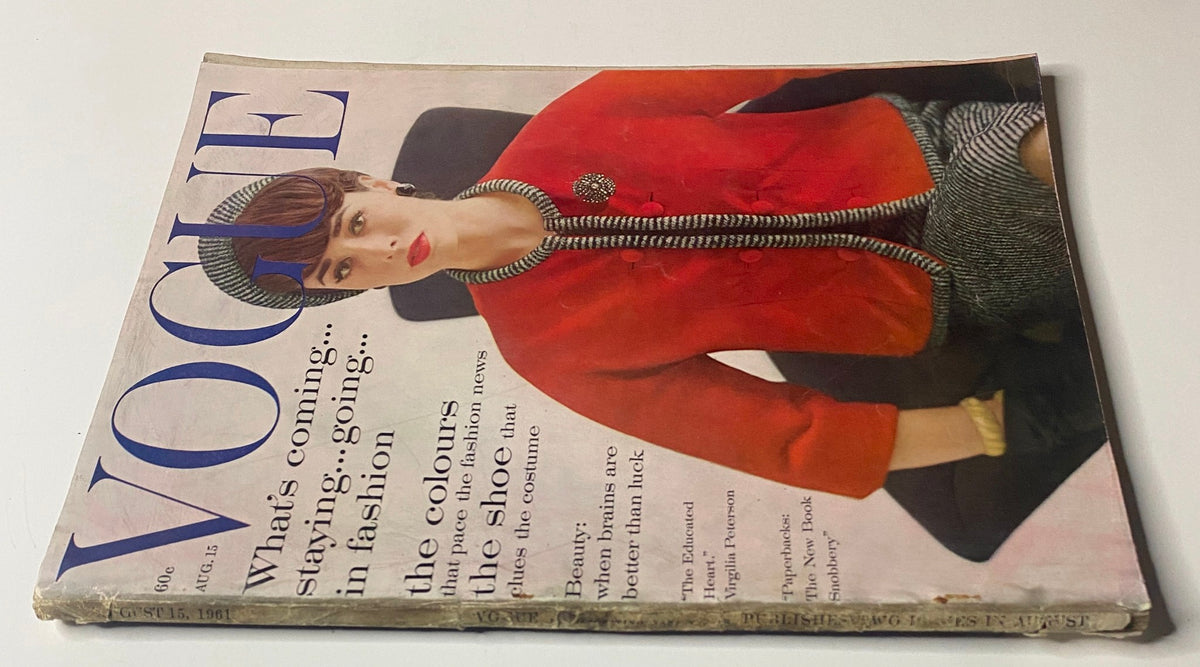 Vogue Magazine August 15, 1961 featuring a striking cover with Sondra Peterson styled in a vibrant red jacket, photographed by Karen Radkai. The magazine highlights late-summer fashion with an emphasis on sleek silhouettes and rich colors.