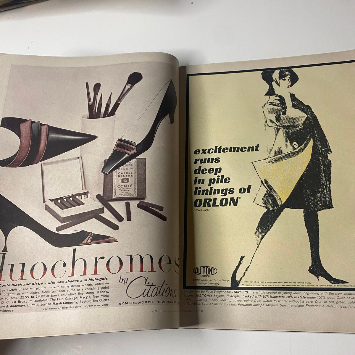 Interior spread from Vogue Magazine August 15, 1961 featuring fashion accessories including high-heeled shoes and makeup products alongside an advertisement for Dupont's ORLON fabric, showcasing the elegance of early 1960s style.