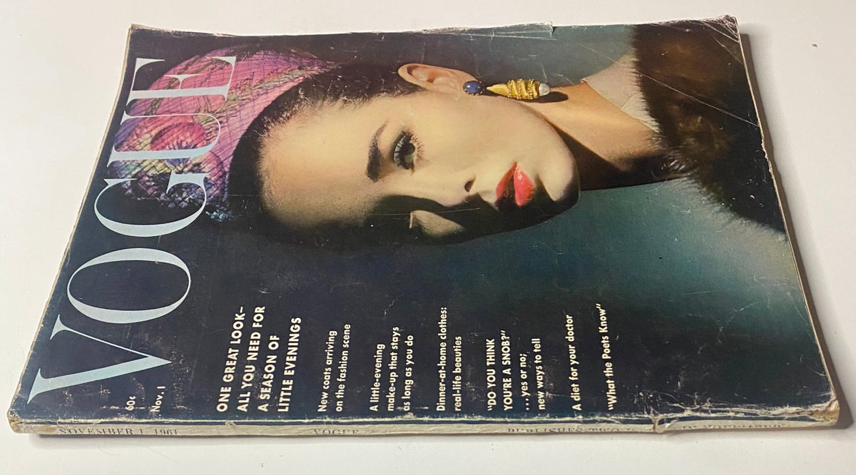 A close-up view of Vogue Magazine November 1, 1961 cover featuring Sondra Peterson, showcasing a glamorous look with bold earrings and a striking pose.