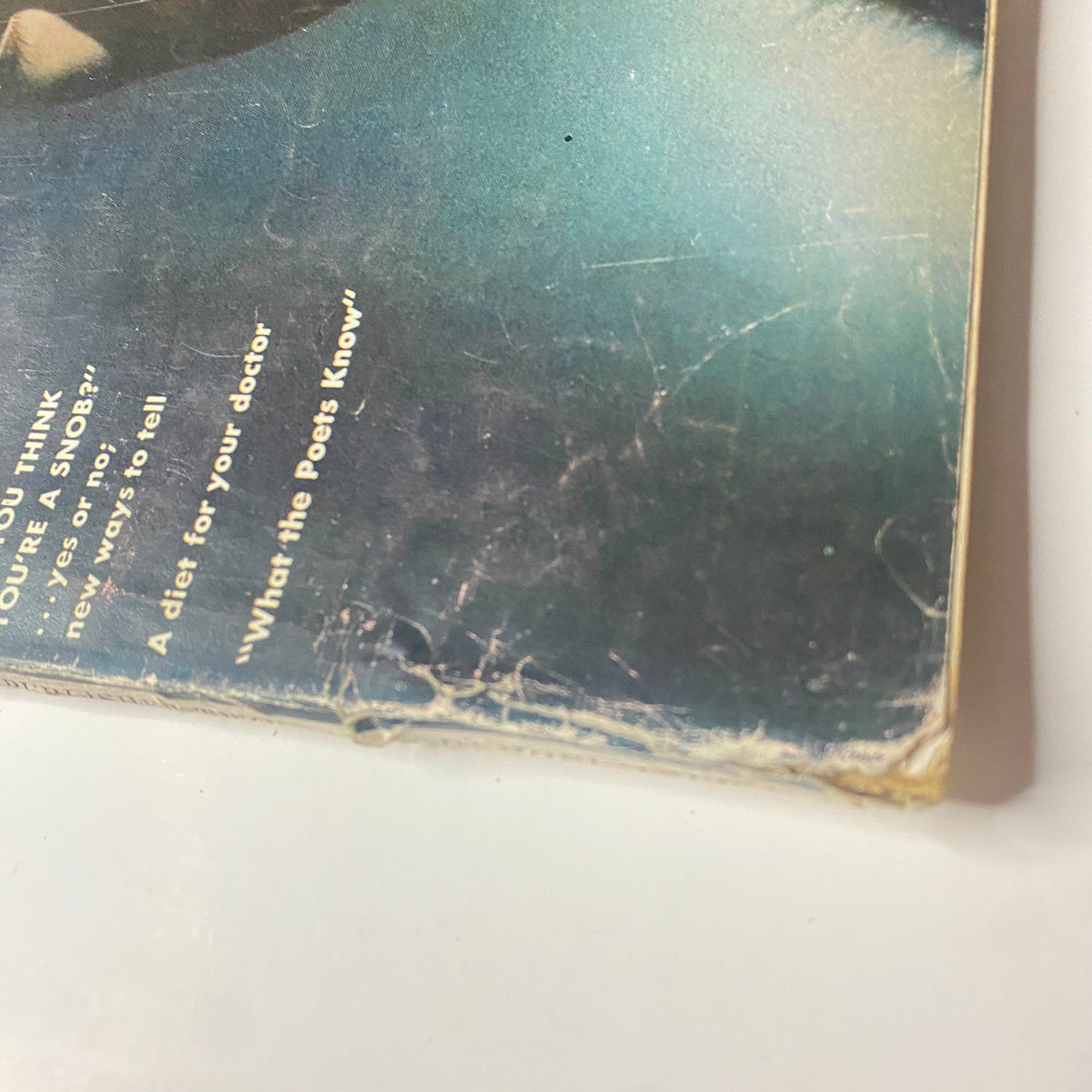 Close-up shot of the lower corner of Vogue Magazine November 1, 1961, with Sondra Peterson's cover and slight wear visible, displaying the magazine's vintage charm.