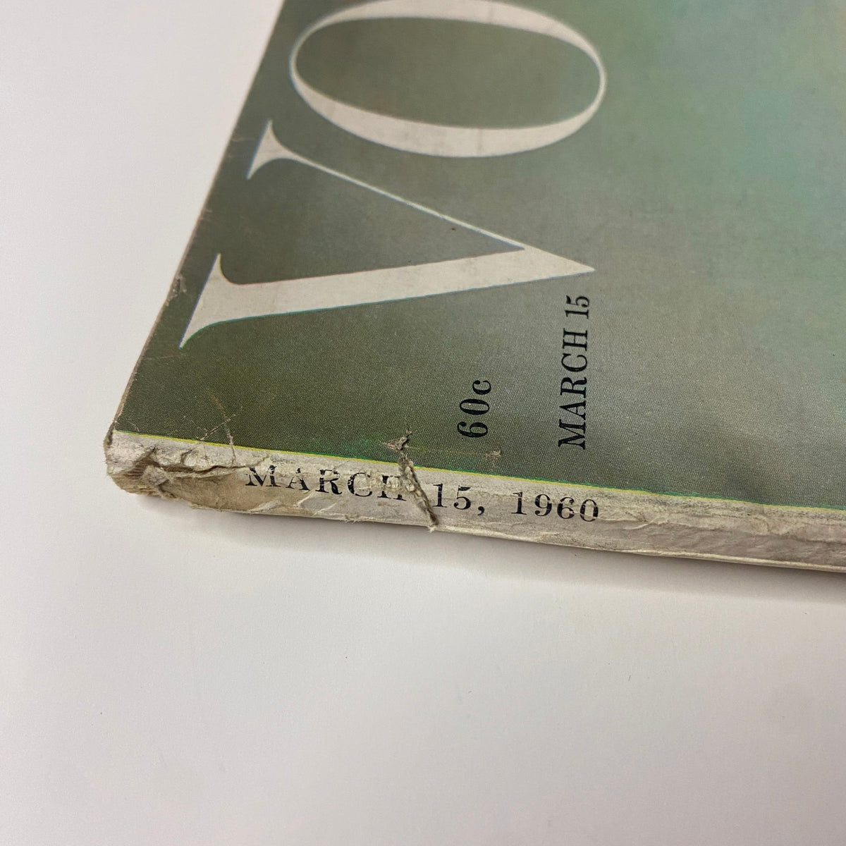 Spine detail of Vogue Magazine March 15, 1960, showcasing the date and magazine title, reflecting its vintage charm and collectible status.