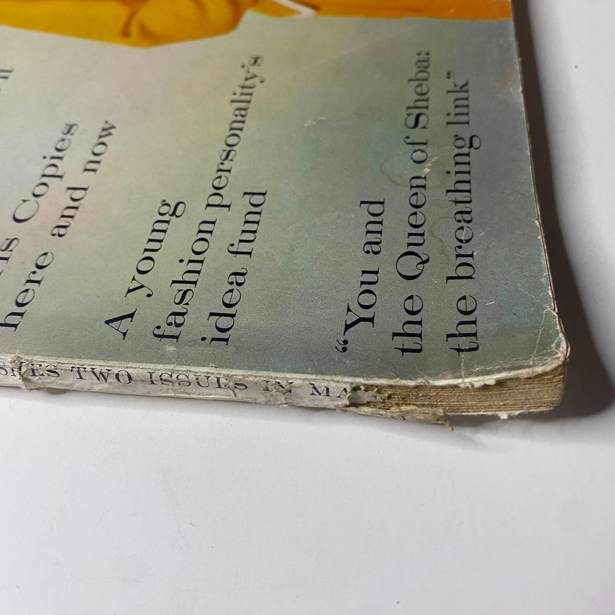Close-up view of the edge of Vogue Magazine March 15, 1960, featuring Lisa Bigelow on the cover by Horst P. Horst, showing some wear and vintage characteristics.