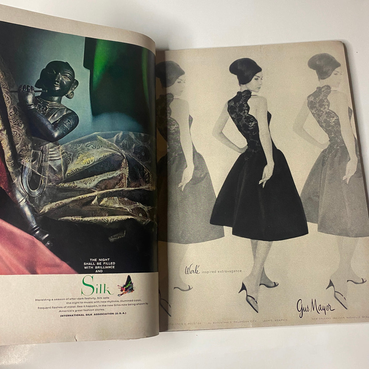 Two-page advertisement from Vogue Magazine October 1, 1960, showcasing elegant fashion designs with a model in a classic black dress, reflecting the period's haute couture.