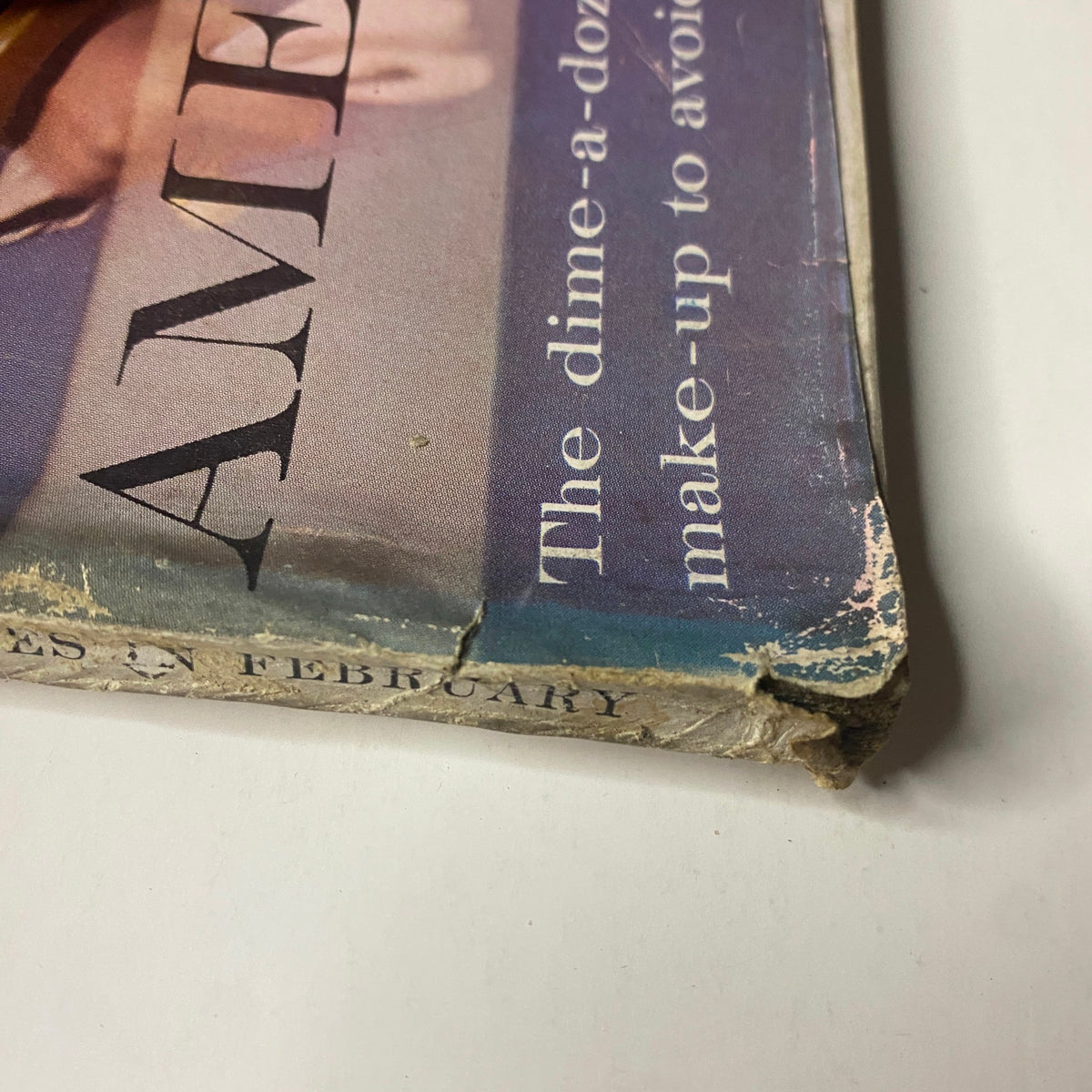 Another view of the spine of Vogue Magazine February 1, 1961, highlighting the vintage characteristics and wear consistent with its historical importance.