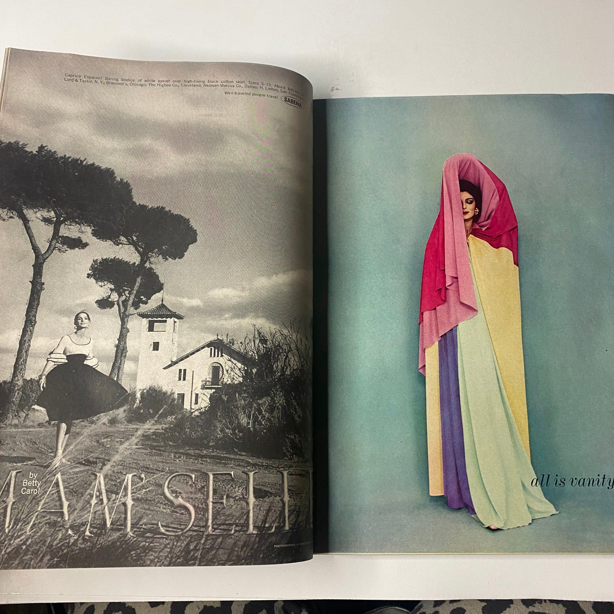 Stylish editorial spread from Vogue Magazine February 1, 1961 featuring two models in elegant attire against a scenic backdrop, highlighting fashion innovation of the early 1960s.