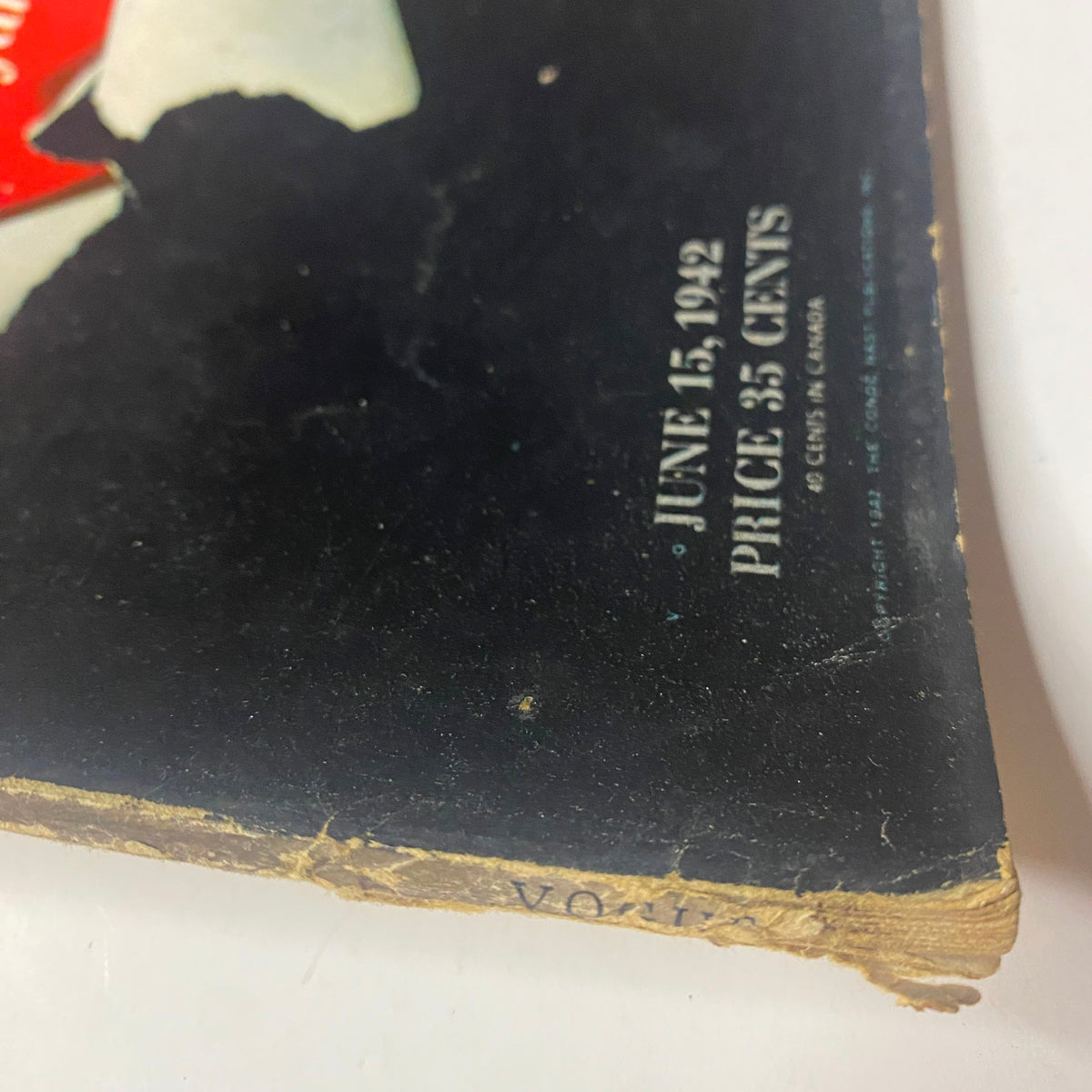 Side view of Vogue Magazine June 15, 1942, showing the spine and edge wear, reflecting its historical value and authenticity.