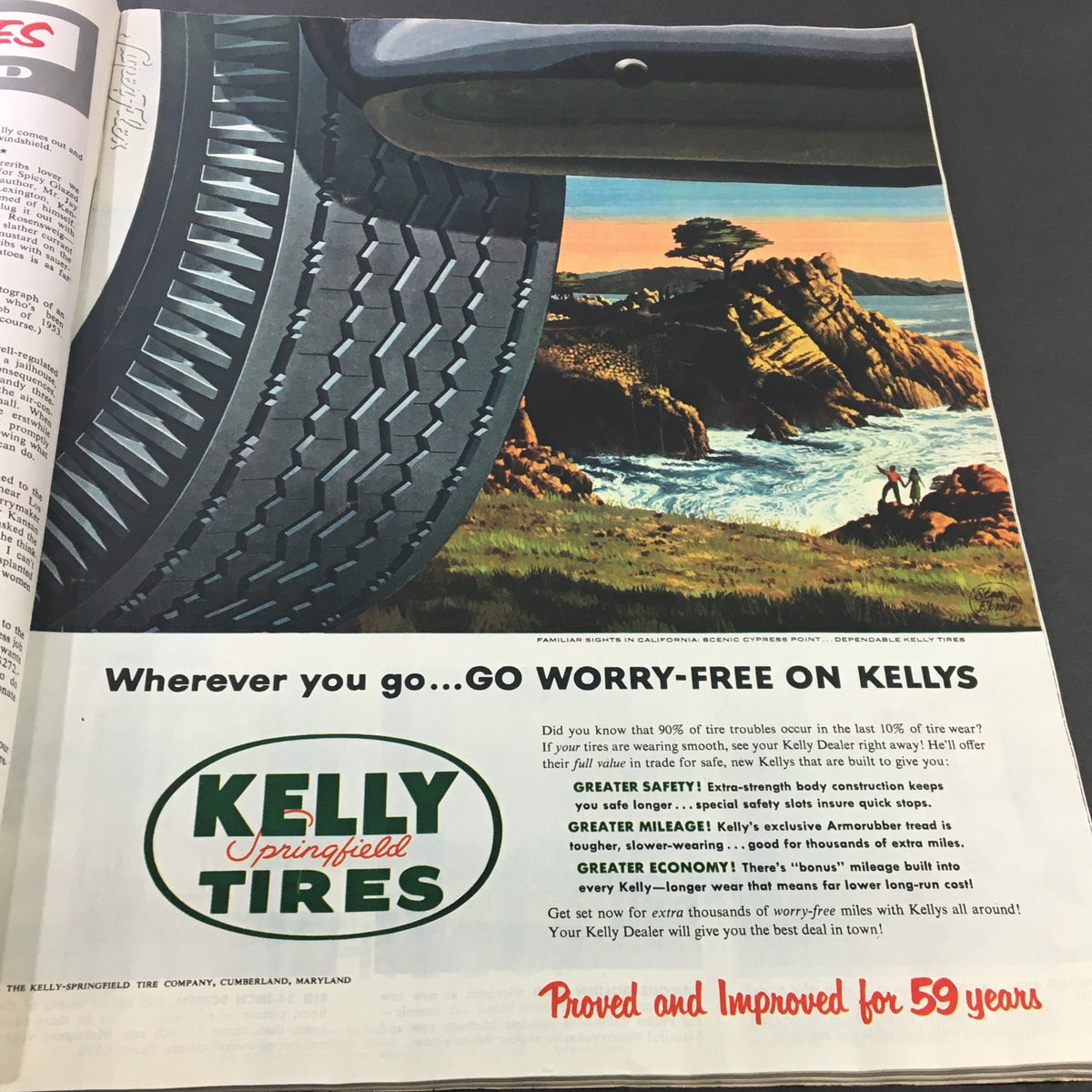 Vintage advertisement for Kelly Springfield Tires from VTG Collier's Magazine October 16 1953, featuring a scenic coastal image and promoting tire safety and longevity.