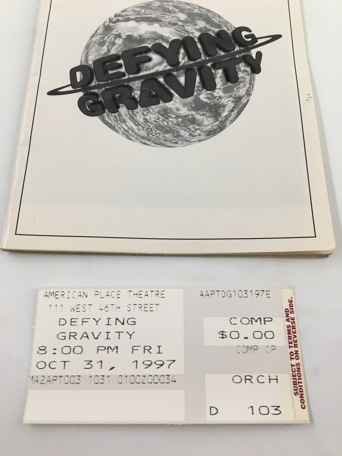 Close-up of the 1997 Playbill from The American Place Theatre for Defying Gravity, including the original ticket for the performance on October 31, 1997.