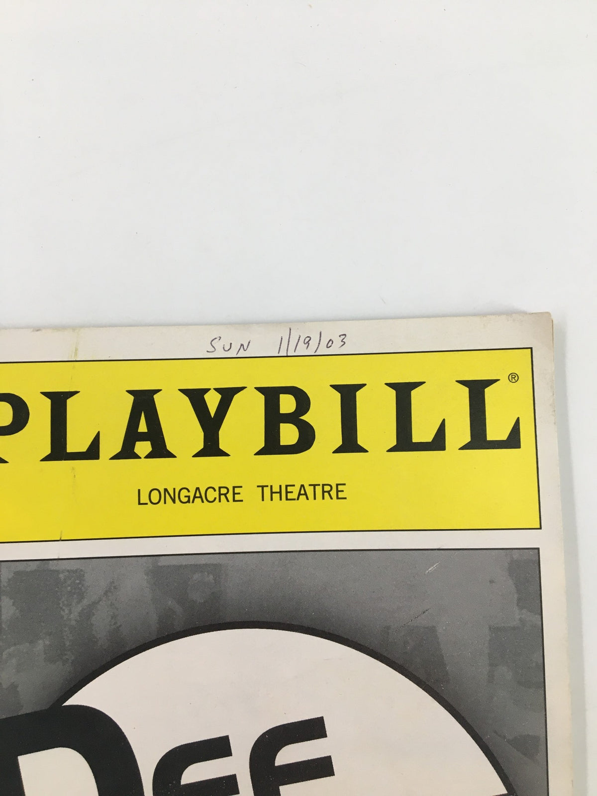 Close-up view of the top of the 2003 Playbill from Russell Simmons Def Poetry Jam on Broadway, showing date written and Longacre Theatre details.