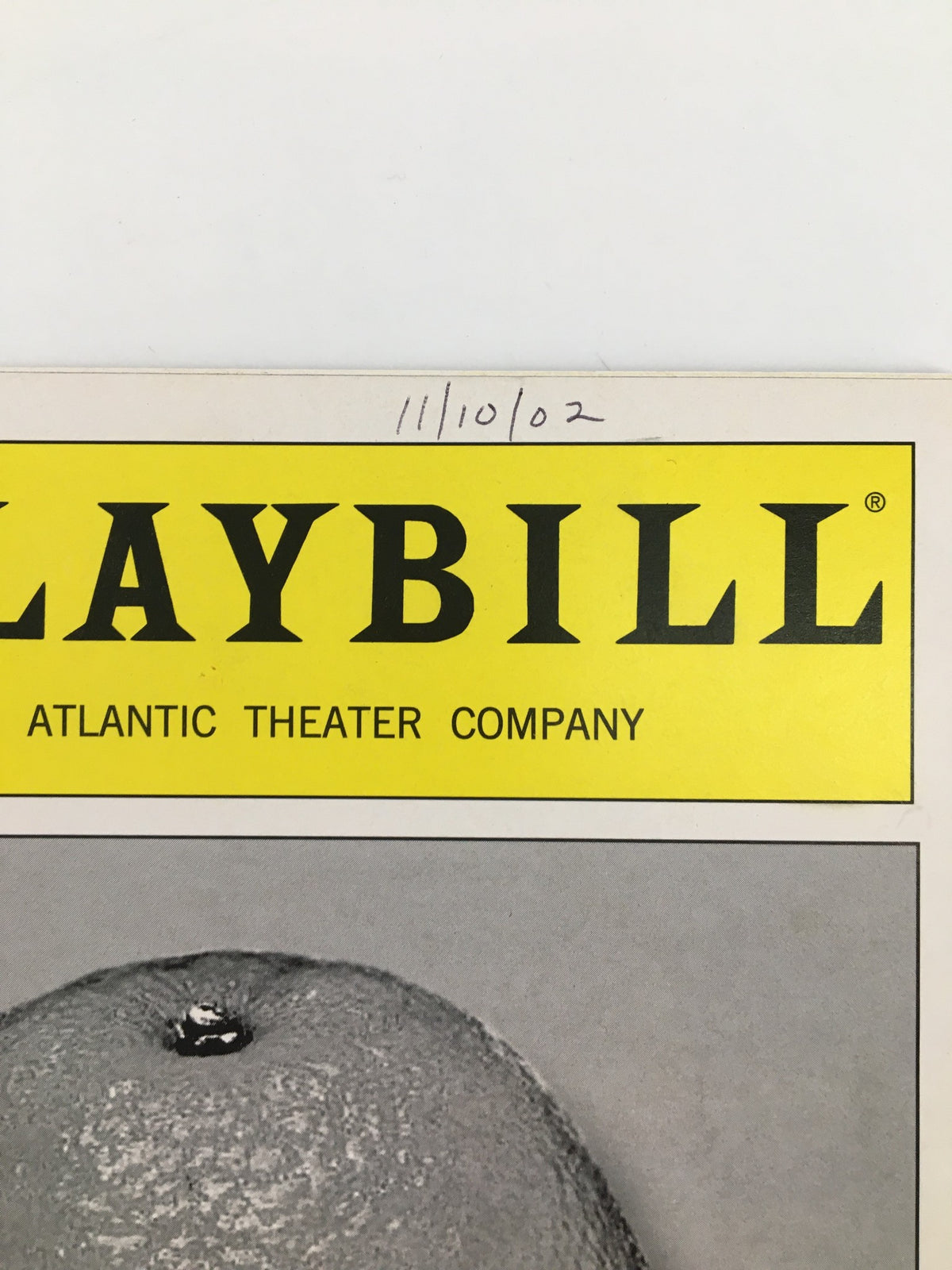Close-up of the 2002 Playbill from the Atlantic Theater Company featuring Glenn Fitzgerald in Blue / Orange, highlighting the title in bold yellow lettering.