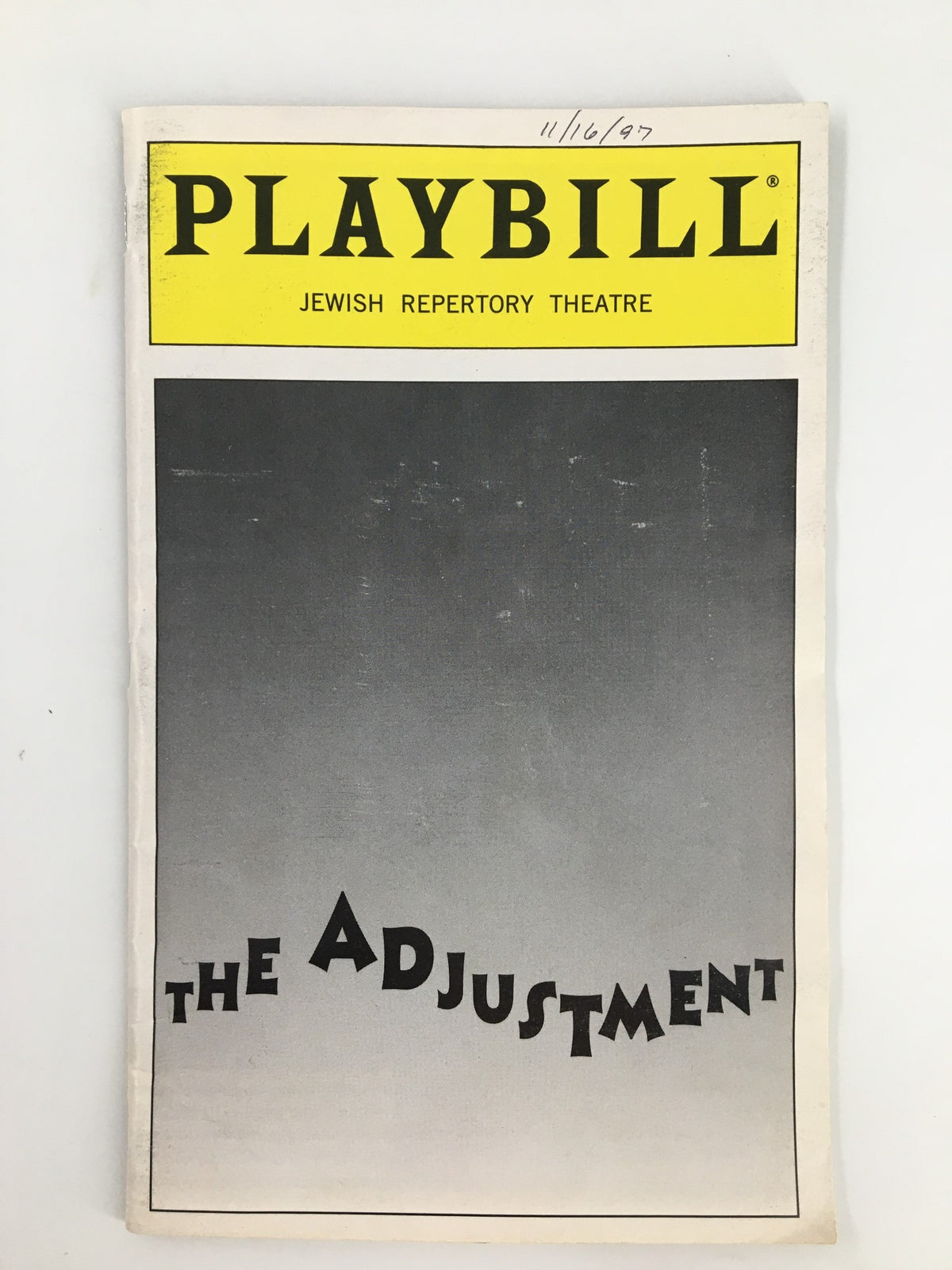 1997 Playbill for The Adjustment, featuring the title and a gradient background, from the Jewish Repertory Theatre.