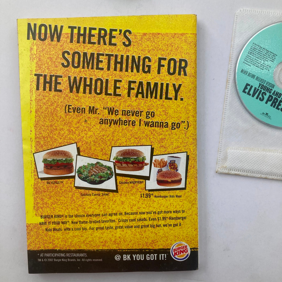 Back cover of TV Guide Magazine August 17 2002 featuring Elvis Presley with a Burger King advertisement. Includes images of burgers and the phrase 'Now there's something for the whole family.'
