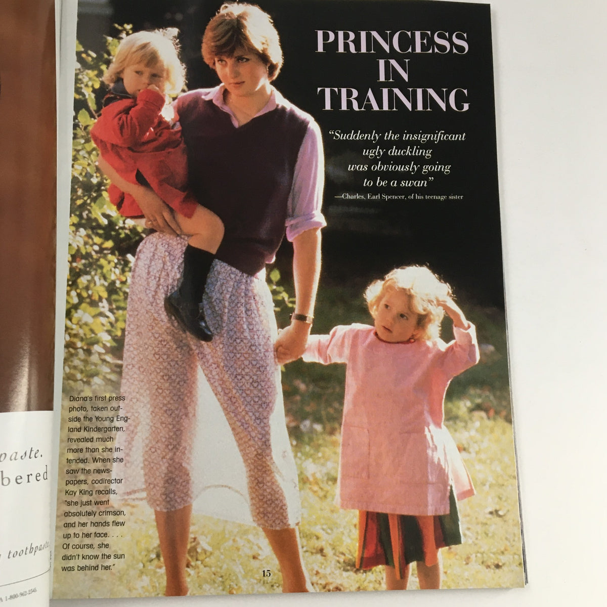 Diana, Princess of Wales, holding a child and dressed casually while engaging with her young companion, depicted in People Weekly Magazine Fall 1997.